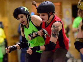 Eddy Nigma of the Headstone Honeys connects with Gang Green's Jesica Albad during a bout held at CFB Shilo on May 11.The score of the Honeys first bout was 371 to 146 for Brandon's Gang Green. Submitted Photo by Henry Leung.