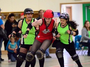 Eddy Nigma of the Headstone Honeys makes her way through two blockers during a bout held at CFB Shilo on May 11.The score of the Honeys first bout was 371 to 146 for Brandon's Gang Green. Submitted Photo by Henry Leung.