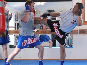 A Muay Thai instructor demonstrates an attack move.