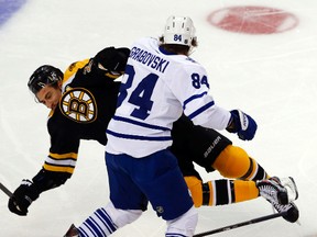 Maple Leafs centre Mikhail Grabovski collides with the Bruins’ Chris Kelly during the first period of Game 7 at TD Garden in Boston on Monday night. (Michael Peake/Toronto Sun)