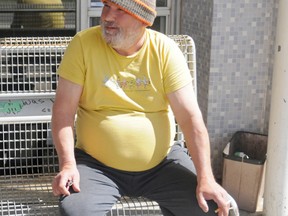 Chris Stafford sits outside the Helma Fletcher Building on 98 Street on Monday. He and the other tenants of the shelter are angry and upset about its end-of-May closure, which was ordered by the City of Grande Prairie after inspection revealed the building was unsafe. Elizabeth McSheffrey/Daily Herald-Tribune
