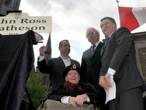 Retired Judge John Matheson, seated, is surrounded, from left, by Brockville Mayor David Henderson, Leeds-Grenville Warden Ron Holman and Leeds-Grenville MP Gord Brown, who unveiled a street name in recognition of Matheson's key role in designing the Maple Leaf flag in 1965. (NICK GARDINER The Recorder and Times)