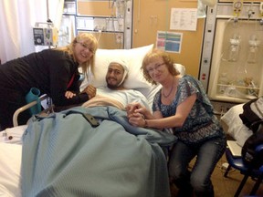Denise Didone, left, and her sister Lousie Seguin visit with Joe Azougar at Lady Minto Hospital in Cochrane, Ont., on Monday, May 13, 2013.
