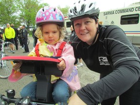 Arrlynn Frais, with the Sarnia Probation and Parole office, brought her daughter Molly Frais, 3, with her to be part of Tuesday's Torch Run for the Special Olympics. About 40 local law enforcement representatives ran or cycled in the 6-km event that began in Sarnia's Centennial Park. Sarnia, Ont., May14, 2013 (PAUL MORDEN, The Observer)