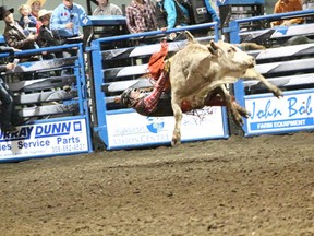 A rider at the Nipawin Rona PBR holds on for dear life, and points, during the event held Friday, May 10 at the Centennial Arena.