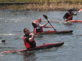 Jason Allen prepares to pass to Scott Forbes (middle) with Brad Cameron (upper left) also attacking. The Canadian national canoe polo team was in Grande Prairie, Alberta over the weekend for practice sessions in Muskoseepi Park. Saturday, May 11, 2013.  TERRY FARRELL/DAILY HERALD-TRIBUNE