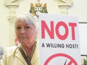 MONTE SONNENBERG Times-Reformer
Wind turbine opponent Shana Greatrix of Port Ryerse brandished this sign at Tuesday's meeting of Norfolk council. Simcoe Coun. Charlie Luke tabled a motion saying Norfolk was no longer "a willing host" for further turbine development. Council supported the resolution in an 8-1 vote.