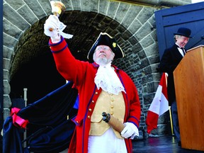 Town crier Lawrence Levere proclaims the induction of the Brockville railway tunnel into the Canadian Railway Hall of Fame on Tuesday evening. In the background is railway tunnel committee member Brian Porter. (RONALD ZAJAC/The Recorder and Times)