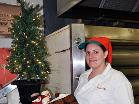 Dooher's Bakery employee Rachel Whitton displays some fresh-baked Christmas pudding Monday. A film crew from Food Network's Food Factory television show was in Campbellford to record the making of the bakery's traditional Christmas pudding for a Christmas special to be aired some time in December.