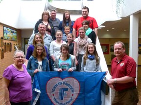 Fairview Town councillor Anne Grayson, (far left) and Mayor Gord MacLeod, (far right) presented Town flags as gifts to visiting exchange students Margaux Philibert, Jennifer Da Costa and Marjolaine de Morgues (holding flag), all from Lyon, France