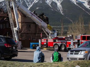 Canmore Suites residents observe the aftermath of a fire that ripped through part of the complex early Friday, May 11, 2013. Justin Parsons/ Canmore Leader/ QMI Agency