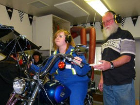 Caitlynn Campbell of Kinuso concentrates as she cranks the throttle wide open on a 2006 Harley motorbike during GPRC Fairview College Trades Camp. Students from all over the Peace came Thursday, stayed overnight in the dorms and got to try out three of them. The list included motorcycle mechanic, plumbing, carpentry, and parts. Wally Besler, program chair for the motorcycle mechanics program supervises as he put students through dynamometer runs on the Harley.