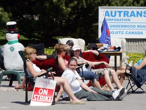 Striking Autrans employees make themselves comfortable on couches and lawn chairs as they block the vehicle entrance to the factory in 2006. (File photo)