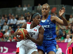 Canada’s Tamara Tatham runs into Sandrine Gruda of France during women’s basketball competition at the 2012 Olympic Summer Games in London. File Photo/QMI Agency