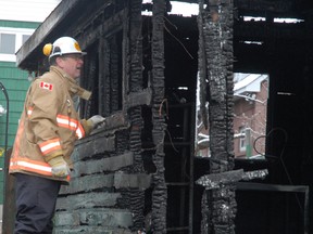 Insp. Dan Fraser checks a fire scene at 342 5th Ave. in 2013. Firefighters, and support staff, team up for a weekend hockey fundraiser at Soo Pee Wee Arena.