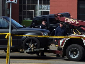 Tow trucks remove two vehicles from a parking lot at the Hex Lounge, 10725 104 Ave. Wednesday, May 15,  2013.  Police were flagged down about 1:45 a.m. to find a stabbed man in the lounge who later died in hospital.  (Perry Mah/Edmonton Sun)