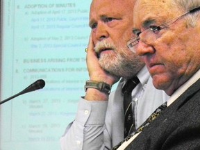 Frontenac Islands Township councillor David Jones, left, and Mayor Denis Doyle listen to the discussion of Jones' motion calling for the removal of Frontenac County Warden Janet Gutowski Wednesday morning. 
Elliot Ferguson The Whig-Standard