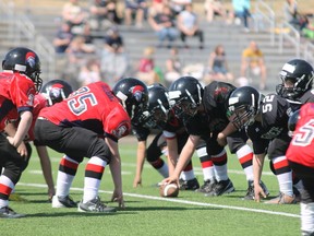 Members of the Anzac Wolves Peewee football team (in black) line up against the Thickwood Spartans in a controlled scrimmage game at TC Park on May 11. TREVOR HOWLETT/TODAY STAFF