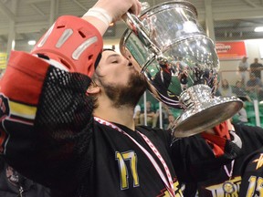 Sheldon Burns from the Whitby Warriors kisses the Minto Cup in 2011. Since 2014 Canada's junior A lacrosse title has been decided in an east meets west best-of-seven series, rather than a round robin leading up to a final game. Postmedia Network file photo