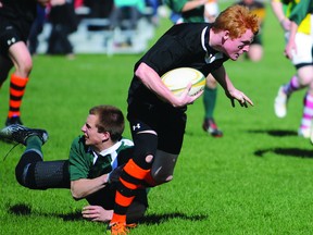 AARON HINKS/DAILY HERALD-TRIBUNE
Grande Prairie Composite High school Warrior Madison Radersma finds his way through a tackle from St. Joseph High school Celtic Braydon Germann during their rugby match Tuesday evening at Macklin Field. The Comp moved to 3-0-0 on the season, with a 32-12 victory over the 0-2-0 Celtics.
