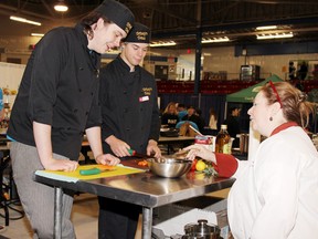 Shane Dussault (left) and Dylan Egan, Grade 12 and Grade 11 students respectively at Fellowes High School, competed in the culinary arts competition of the Options Skilled Trades Fair held in Pembroke Wednesday. They are receiving some pointers from Marion Ullrich of Ullrich's on Main, who served as a judge for the culinary competition.