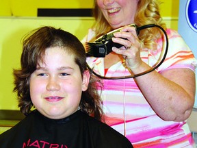 SEAN CHASE Eric Zadow doesn't mind losing his locks for a good cause. After raising $2,205, the Our Lady of Lourdes student sat down for the hair cut delivered by hairdresser Colleen Lanthier.