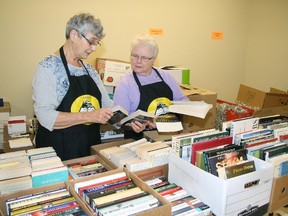 Barb Archer, left, and Anne Beck sort through the wide selection of books donated to the Friends of the Nan Boothby Library for their upcoming Beyond Words Sale, June 1-2. The Friends do welcome more books, CDs, DVDs and pictures for the sale.