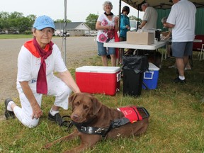 Three-year-old vision services dog Buster poses with his owner Verna Letoureau, who lost most of her vision to glaucoma, in the 10th annual Purina Walk for Dog Guides in Paris, Ontario on Sunday, May 27, 2012. MICHAEL PEELING/THE Paris Star/QMI Agency