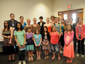 On Saturday the Grande Prairie Public Library honoured this year's winners of the Collins Writing Contest. Now in it's 25th year, the contest is held in memory of Clem and Muriel Collions, who left behind funds to carry on a creative legacy in Grande Prairie, Alberta. Those present to collect their prizes were: (back row, middle) Sue Farrell Holler, Melissa Glover, Nicole Emmett and contest judge Yvonne Mury. (Middle row, far left) Judges Jacob Fehr and Hayley Dolman, Kara Friesen, Katrina Friesen, Rachael Rode, Haley Evens, Faith-Anne Bedard, Nicole Chrenek and Gabrielle Kemp-Webber. (Front row, far left) Amy Young, Kinza Naser, Jenaya Schipper, Kiera Cochrane, Acacia Kabyn, Shelby Lueken and Sydney Kinderwater. (Absent winners: Camryn Winnicky-Lewis, Laine Johner, Marissa Trarback and Judy J. Dettling.) May 11, 2013 KIRSTEN GORUK/DAILY HERALD-TRIBUNE