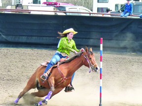 Miranda Giesbrecht rounds the last pole in pole-bending competition during the Worsley High School Rodeo held May 11-12, finishing with a 22.951 time. (Chris Eakin/QMI Agency)