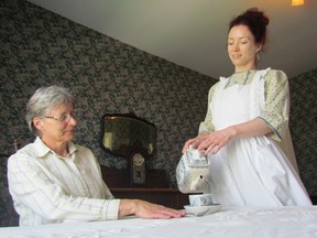 Denise Fortin pours tea for Cathy Seward in the Reilley Cottage on the grounds of the Moore Museum in Mooretown. It will be hosting its annual Victorian Tea Sunday, 1:30 p.m. to 4 p.m., featuring home-baked scones, as well as the opportunity for visitors to look through the museum exhibits. Sarnia, Ont., May 15, 2013 PAUL MORDEN/THE OBSERVER/QMI AGENCY