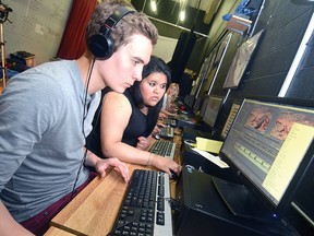 Stratford Central grade 11 students Clay Fowler-Dietrich and Amrita Chahal edit footage Thursday from their class film project shot last weekend. (SCOTT WISHART The Beacon Herald)