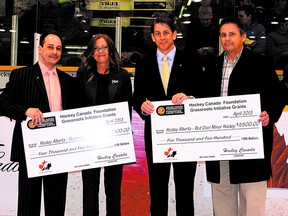 Sherwood Park Minor Hockey and Red Deer Minor Hockey were recently awarded grants from Hockey Canada for developing Grassroots Initiative Programs at the Allan Cup semifinals in Red Deer. From left: Dean Filane-Figliomeni of Hockey Canada, Mary Minnoch with the SPMHA, Chris Bright of Hockey Canada and Dallas Gaume from RDMH. Photo Courtesy Rod Ince Photography