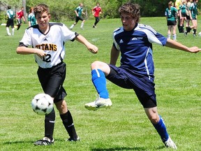 Parkside's Scott Higgs re-directs a ball toward the Central Elgin goal as Titan defender Zach Langley moves in during their TVRA South soccer contest Thursday at Columbus Park near Aylmer. Higgs scored twice as Parkside won 4-2 to wrap up the regular season. R. MARK BUTTERWICK / St. Thomas Times-Journal / QMI AGENCY