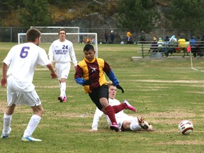 Beaver Brae’s Joel Arsenault slide tackles a Crocus Plains player knocking the ball out from under his feet whiel teammates James McDougall and Davin Iverson look on. Arsenault scored one goal in Beaver Brae’s 3-1 victory over Fort Frances on Wednesday, May 15. 
GRACE PROTOPAPAS/Daily Miner and News