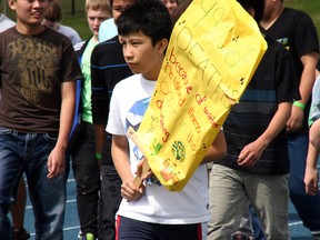 Raising $11,000 for the hour and a half long event, students at Holy Trinity Catholic High School took to the track to raise funds for Walk for Water — a Free the Children Event — Thursday. Amanda Richardson/Today staff