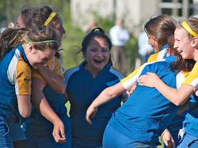 Members of the BCI junior girls rugby team celebrate their championship win over the St. John's on Thursday. (BRIAN THOMPSON, The Expositor)