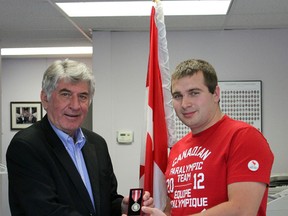 Paralympian Michael Heath accepts his Queen Elizabeth II Diamond Jubilee Medal from Oxford County MP Dave MacKenzie at his Woodstock constituency office Wednesday afternoon. Heath was part of the 2012 Canadian Paralympian team that went to London, England. He swam in the 100-metre breaststroke, 200-metre freestyle and the 100-metre backstroke.

GREG COLGAN/QMI Agency/Sentinel-Review