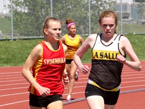 Sydenham’s Nicole Armstrong trails La Salle’s Heather Jaros on the last turn in a combined junior-senior girls 800 metres at Caraco Home Field during the Kingston Area Secondary Schools Athletic Association track and field meet Thursday. Armstong won the race down the stretch and took the senior title while Jaros won the junior portion. (Ian MacAlpine/The Whig-Standard)