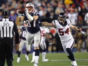 New England Patriots' Rob Grownkowski (L) reaches for a pass past Houston Texans' Barrett Ruud (54) during the first quarter in their NFL AFC Divisional playoff football game in Foxborough, Massachusets January 13, 2013. (REUTERS)