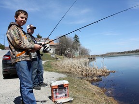 Buddies Patrick Madden, left, and Cam Kirst celebrated their first visit to Timmins by tossing a line into Gillies Lake on a sunny Sunday afternoon. The boys were in town with Madden's father, who was in the city on business from Westport, a small town near Perth, Ont.