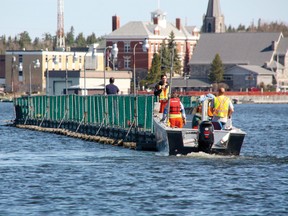 City of Kenora staff remove the Coney Island Bridge Wednesday morning, May 15, 2013. The bridge went in on Nov. 15, 2012.  Due to mechanical problems with the city’s boats, the bridge removal originally planned for Tuesday was delayed one day. This is the latest the bridge has ever been removed but is in time for the Victoria Day long weekend.
MARNEY BLUNT/Daily Miner and News