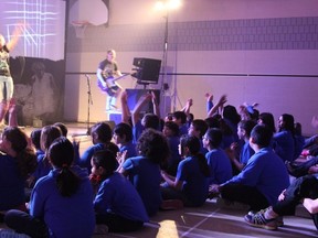 Grade 3 to 8 students at Aileen Wright clapping along with the band Mosely at their Live Different presentation that kicked off Catholic Education Week.