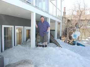 Scott Morrison stands on top of chunks of ice that were blown in off of Lac St. Anne Lake and smashed through his basement windows on May 6. - Brandi Morin, Reporter/Examiner