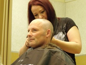 Police sergeant Andy Evans gets his head shaved during the Cops for Cancer shave-off at St.Joseph's School in Port Elgin.