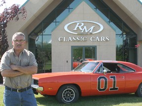 Ernie Morreau, foreman of RM Auto Restoration, poses with the General Lee, a 1969 Dodge Charger owned by RM Classic Cars. It's among the hundreds of vehicles that will be at RetroFest, which takes place in downtown Chatham this Friday and Saturday, May 24 and 25. Morreau will be among the classic car show's celebrity judges. This vehicle was used in the 2005 Dukes of Hazzard movie. The car is autographed by George Barris, who was the creator not only of the General Lee but other well-known cars from TV shows, including the Batmobile and vehicles used in The Munsters. The car is also autographed by John Schneider, who portrayed Bo Duke in the Dukes of Hazzard TV series.