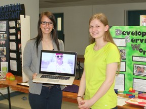 Meagan Bednarik, left, is doing a co-op placement as an educational assistant and Suzi Knelsen is doing a placement as a developmental services worker. Together they jointly produced a music video with students in the life skills program at Ursuline College. Their displays were among those on hand at the school on May 15.