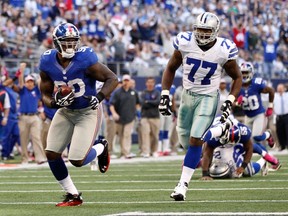 Giants defensive end Jason Pierre-Paul in front of Cowboys offensive tackle Tyron Smith at Cowboys Stadium in Arlington, Tex., Oct. 28, 2012. (MIKE STONE/Reuters)
