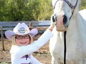 KASSIDY CHRISTENSEN HIGH RIVER TIMES. Chase Robinson, winner of the Little Miss Britches pageant tends to her horse, Rio. Chase will be part of the Little Britches parade on May 20.