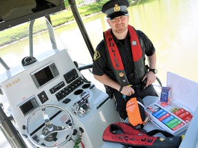 Const. Jason Doran, of the OPP marine unit, displays a small assortment of water safety items every boater should have on board including a first aid kit, personal flotation devices and a rescue throw bag. DIANA MARTIN/Chatham Daily News/QMI Agency file photo